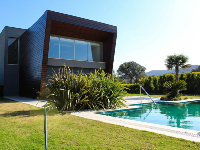 Modern home exterior with pool, one of six real estate listing photos used to create a property video