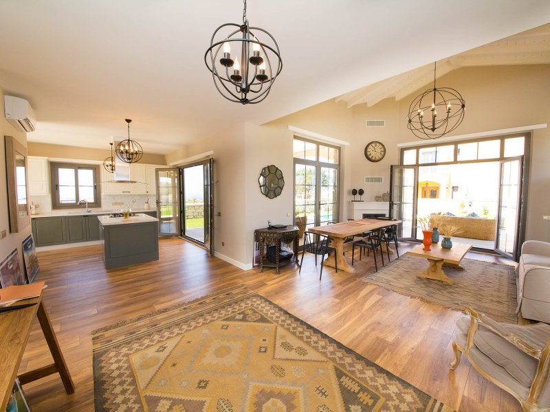 Open-plan living and dining room listing photo prepared for a branded real estate video