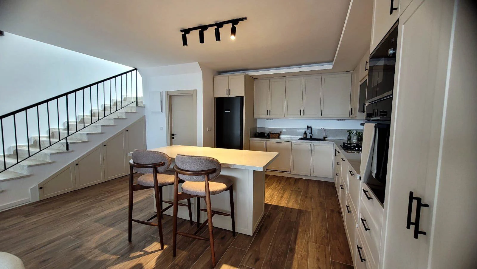 Modern open-plan kitchen with staircase used as a source photo for a vertical real estate video example